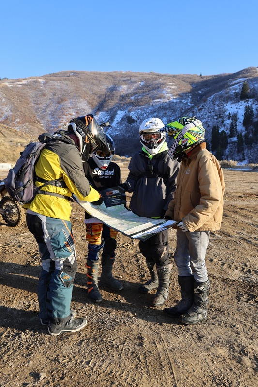 A group of riders checking a trail map